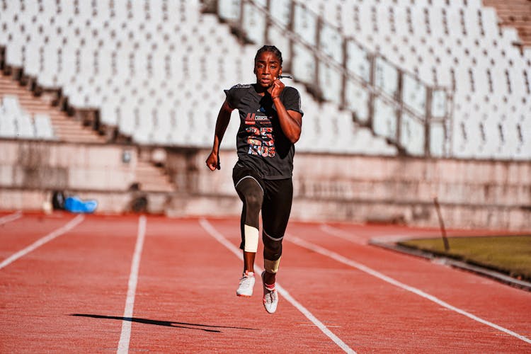 Athlete Running On Stadium