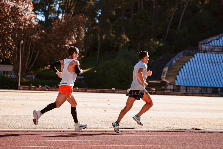 Two Men Running On A Track