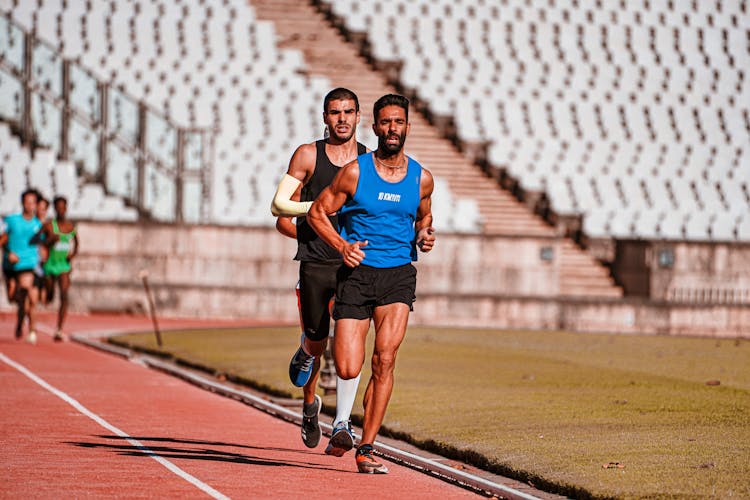 Runners Racing On The Sports Track 