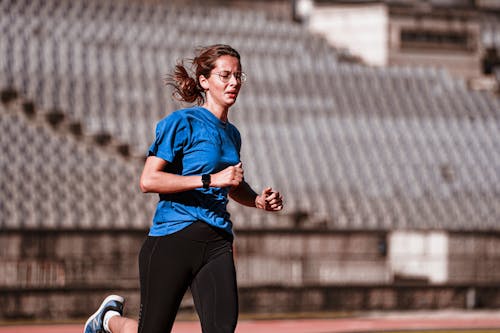 Woman Running on a Running Track