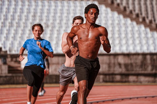 Athletes Running on Running Track