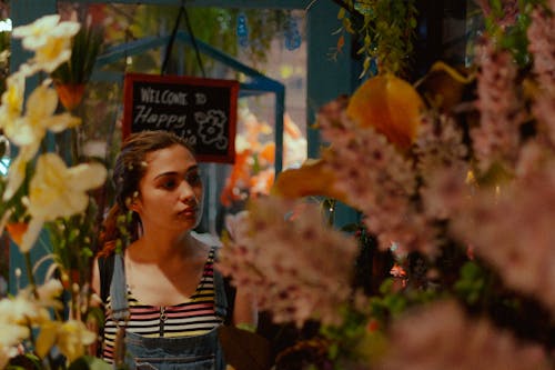 A Woman Standing Beside the Flowers