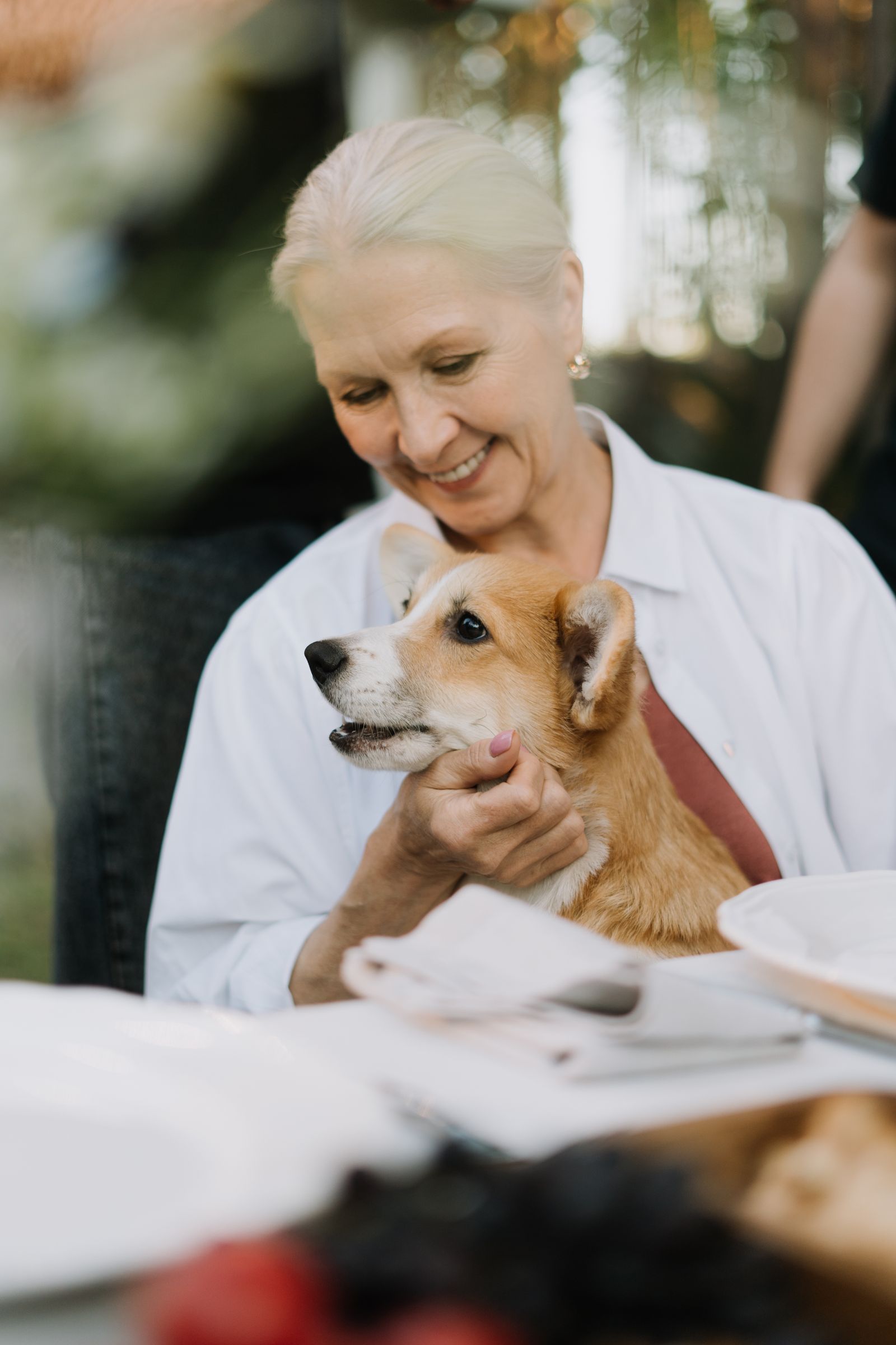 A smiling senior woman holding her pet