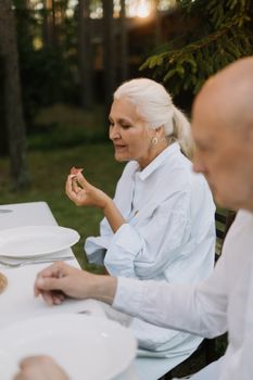 老年人在户外享用美食，被大自然包围，营造出温馨迷人的氛围