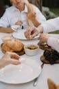 Person Holding Bread on White Ceramic Plate