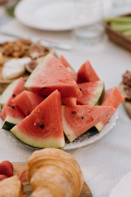 Free Close-up of fresh watermelon slices on a table, perfect for a summer picnic. Stock Photo