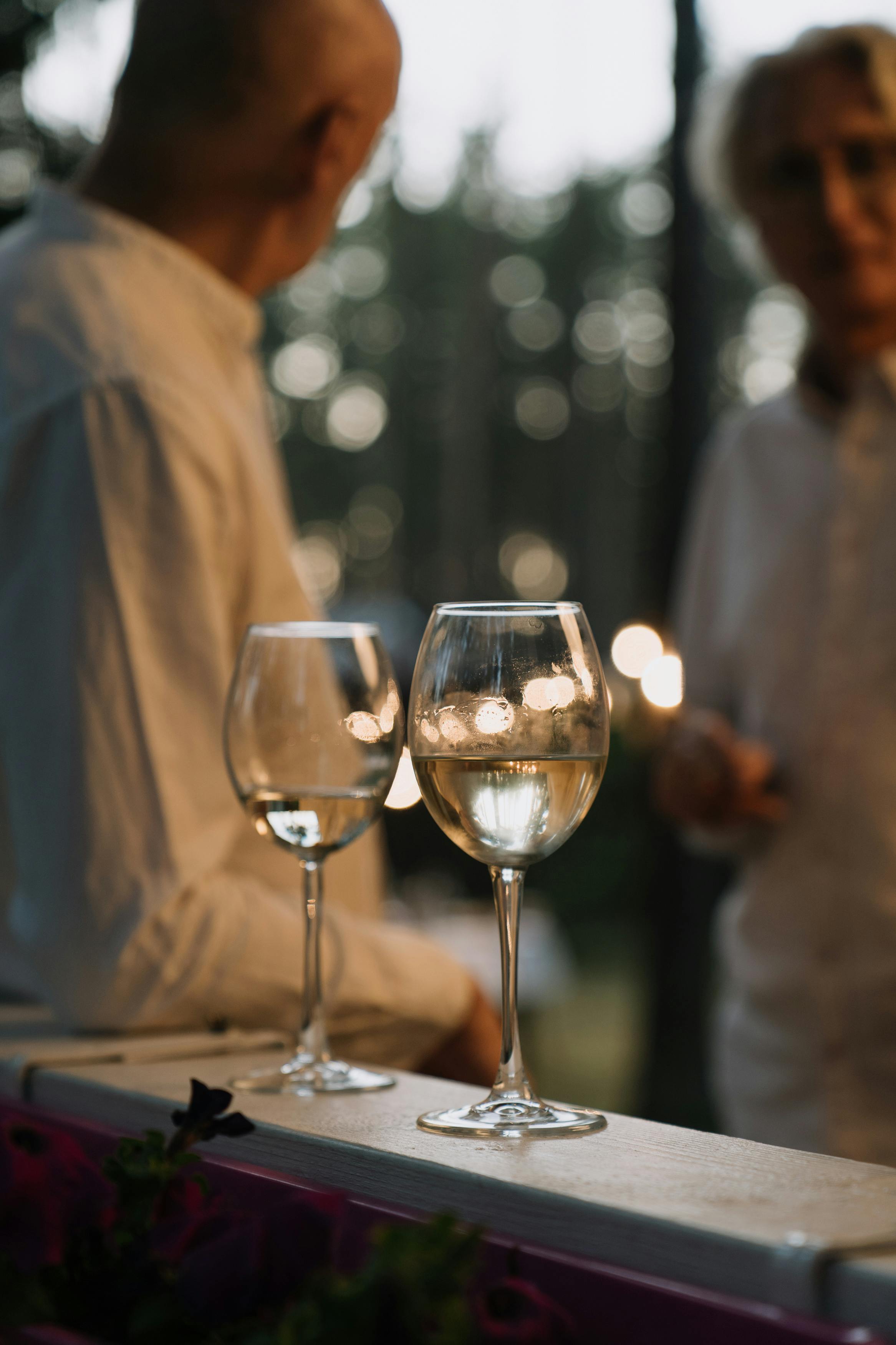 glasses of wine on a wooden railing