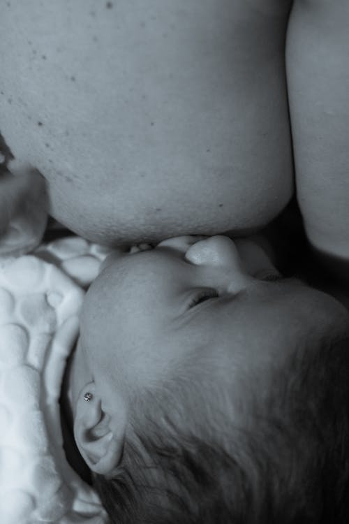 Woman and Baby Lying on Bed