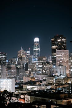 Stunning nighttime view of San Francisco's skyline featuring the illuminated Salesforce Tower.