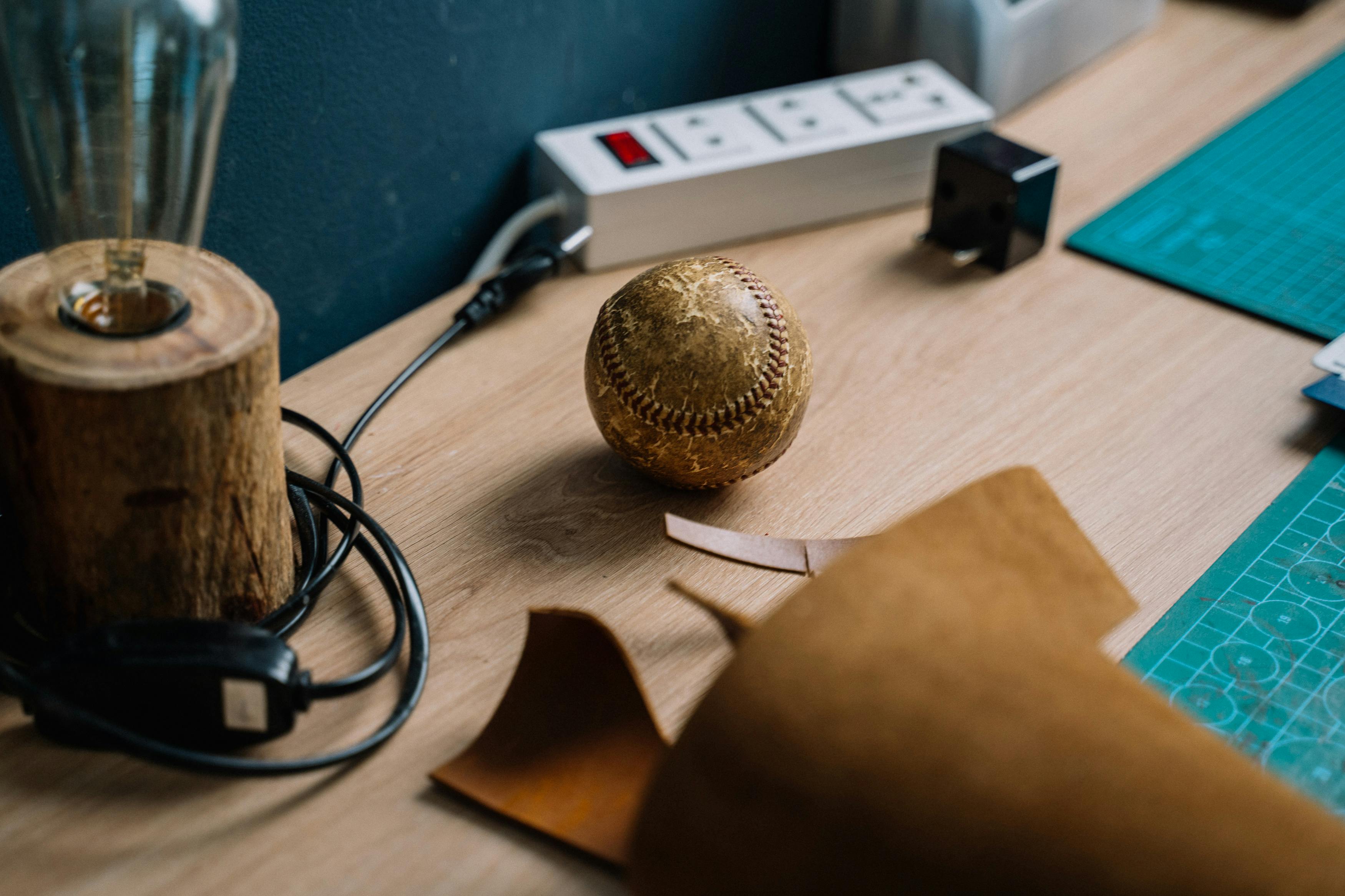 a close up shot of a baseball on a wooden table