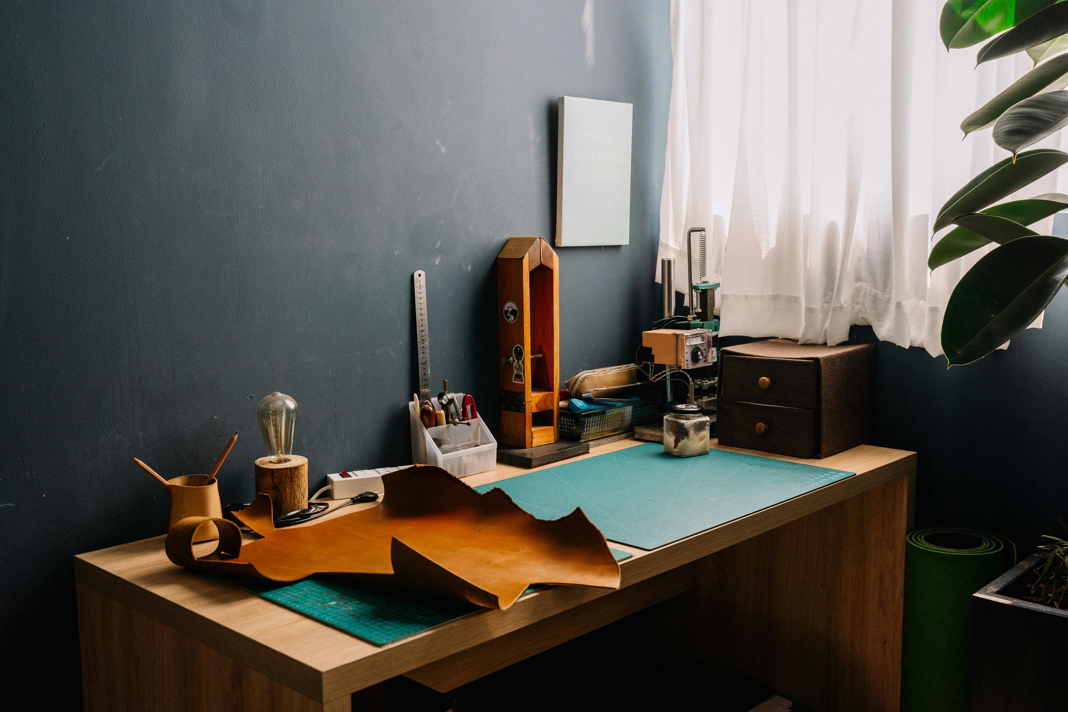 A well-organized artisan workshop featuring tools, leather craft, and natural light.