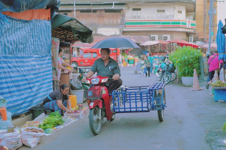 Man Driving A Tricycle On The Street