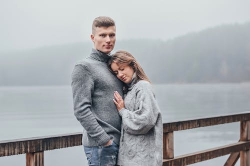 Free Woman in Gray Sweater Leaning on Man's Chest Stock Photo