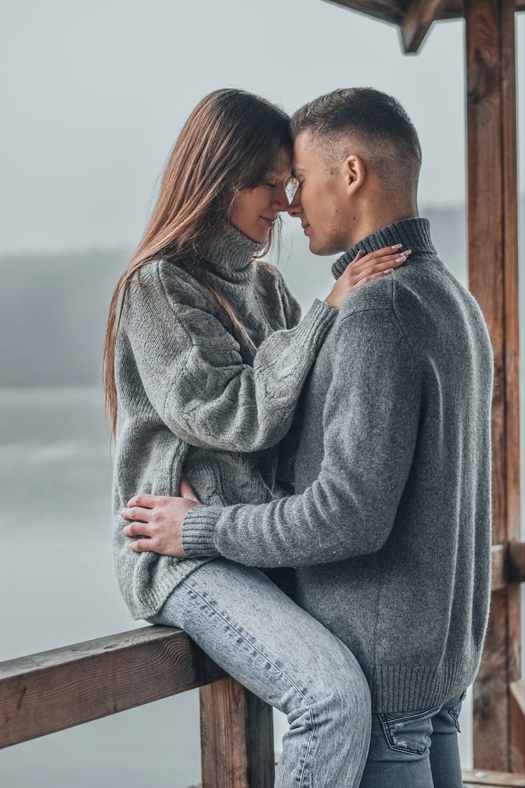 Young Couple Embracing On A Porch 