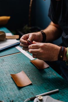Person in Black Leather Strap Watch Writing on Brown Paper