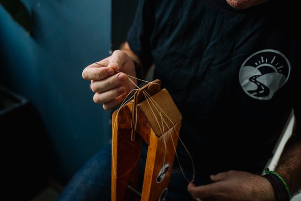 Instructor stitching a leather piece