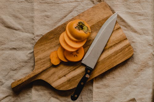 Freshly Sliced Persimmon on a Wooden Chopping Board