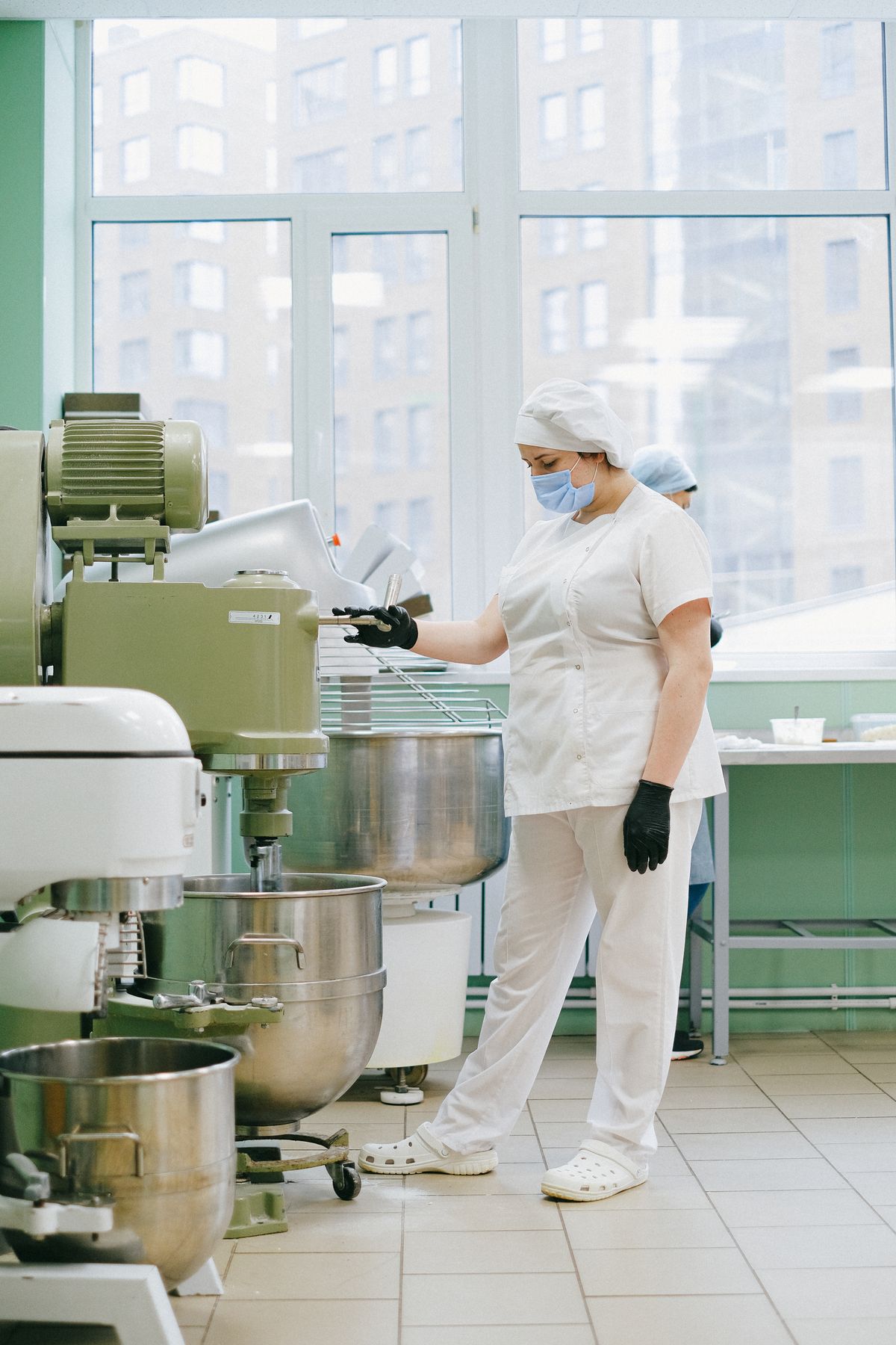 Food industry professional working with hygienic equipment in a production kitchen