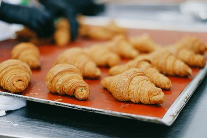 Golden croissants fresh from the oven on a bakery tray, photo by Anna Shvets on Pexels