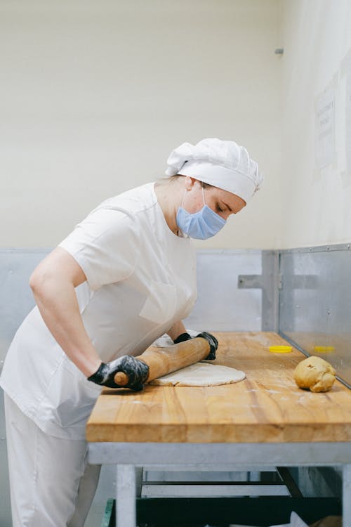 Pastry Chef Flattening a Dough