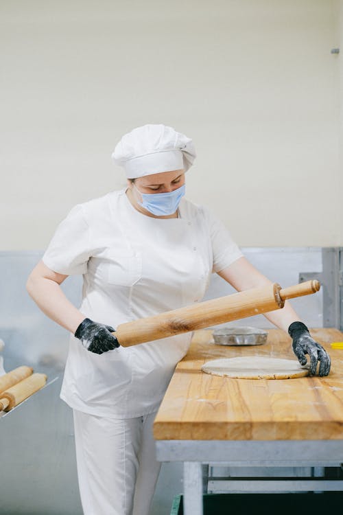 Free Pastry Chef Flattening a Dough Stock Photo