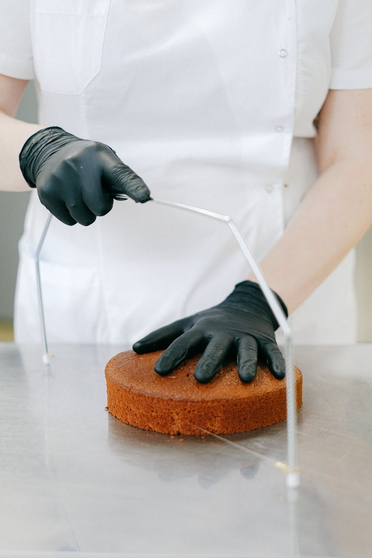 Person Cutting A Cake