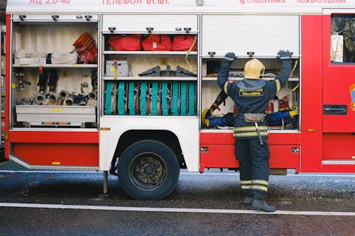 Firefighter in Uniform near Vehicle