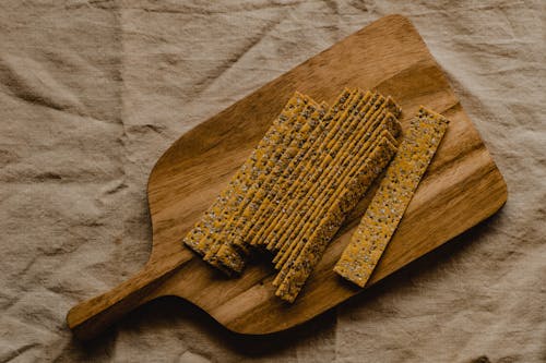 Close-Up shot of Crackers on a Wooden Chopping Board