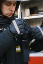 Man Wearing Gloves Holding a Walkie Talkie