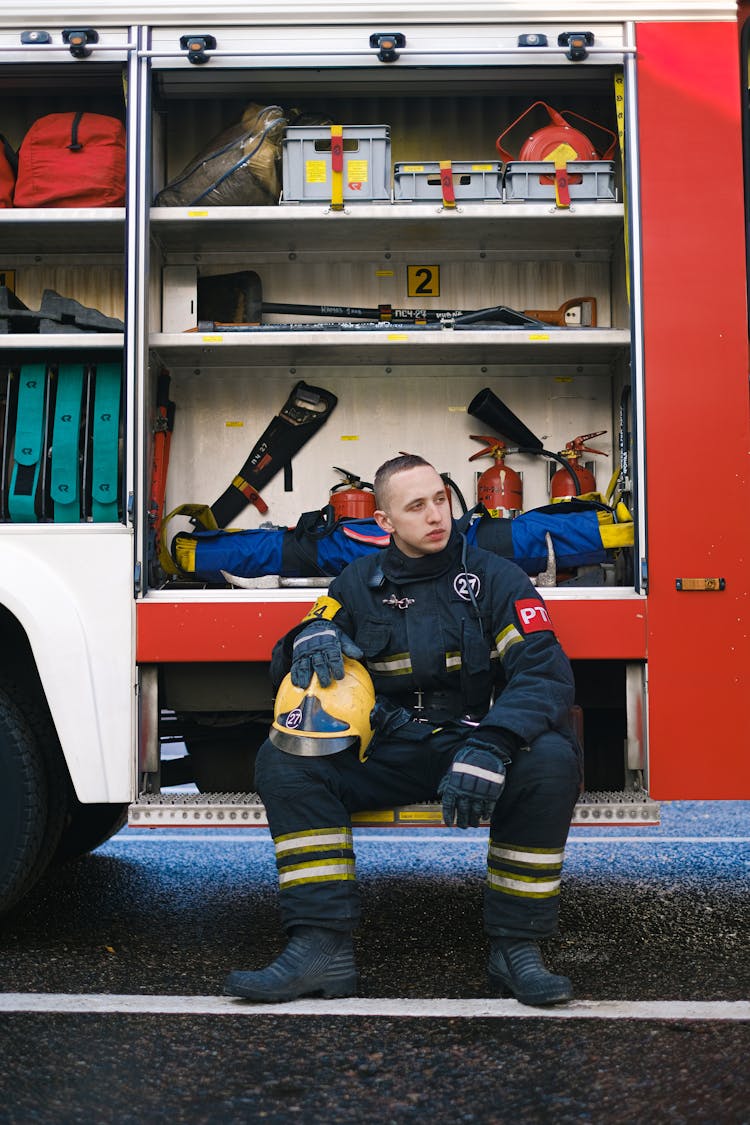 A Fireman Sitting On A Fire Truck