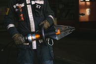 Man in Black Jacket Holding a Power Tool