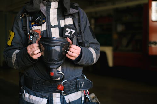 Fire Fighter Holding a Gas Mask