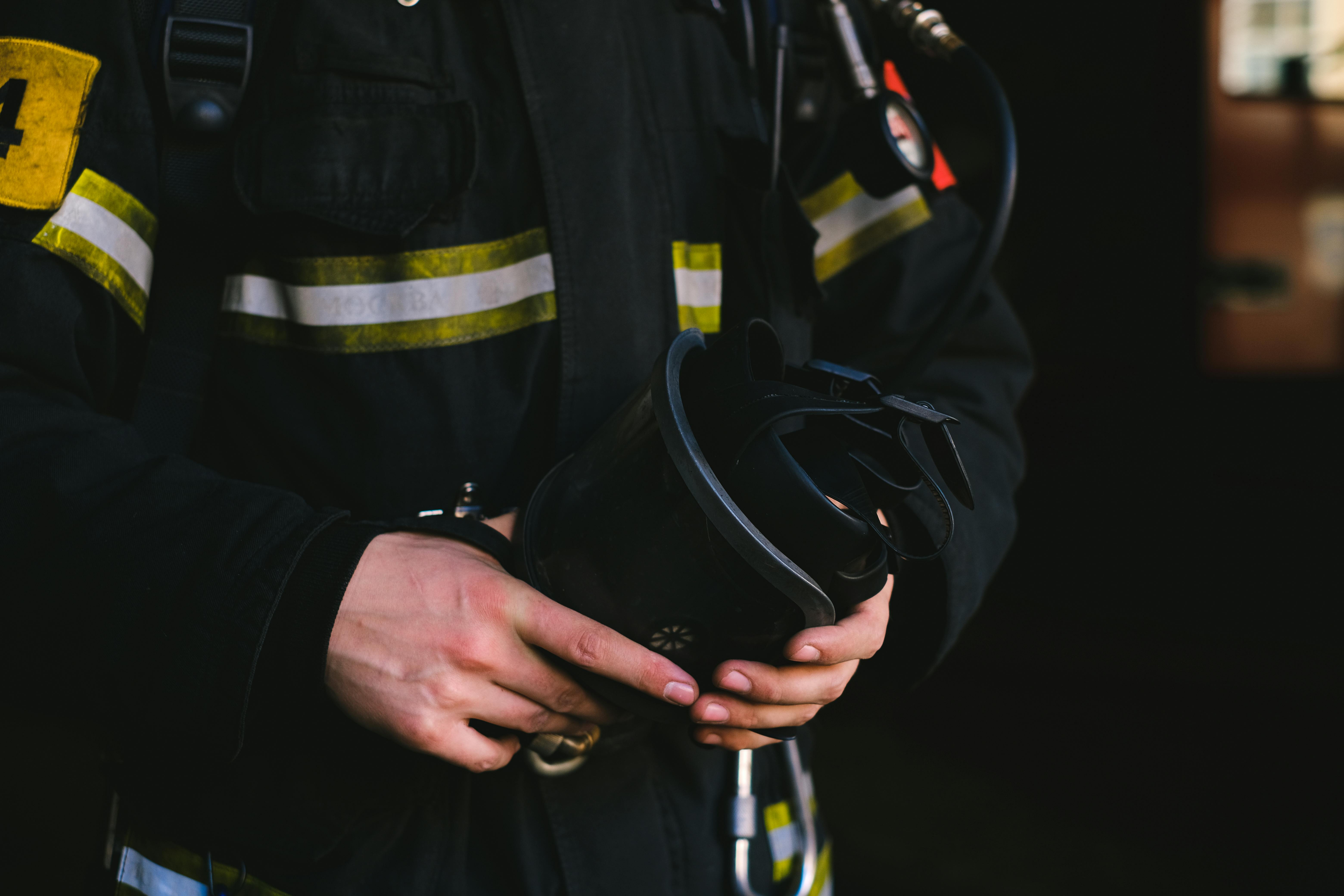 man in a uniform holding safety equipment