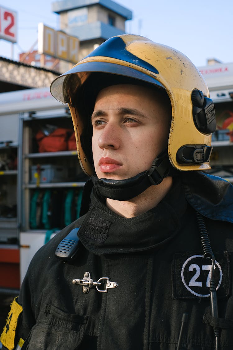 Portrait Of Firefighter In Uniform And Helmet