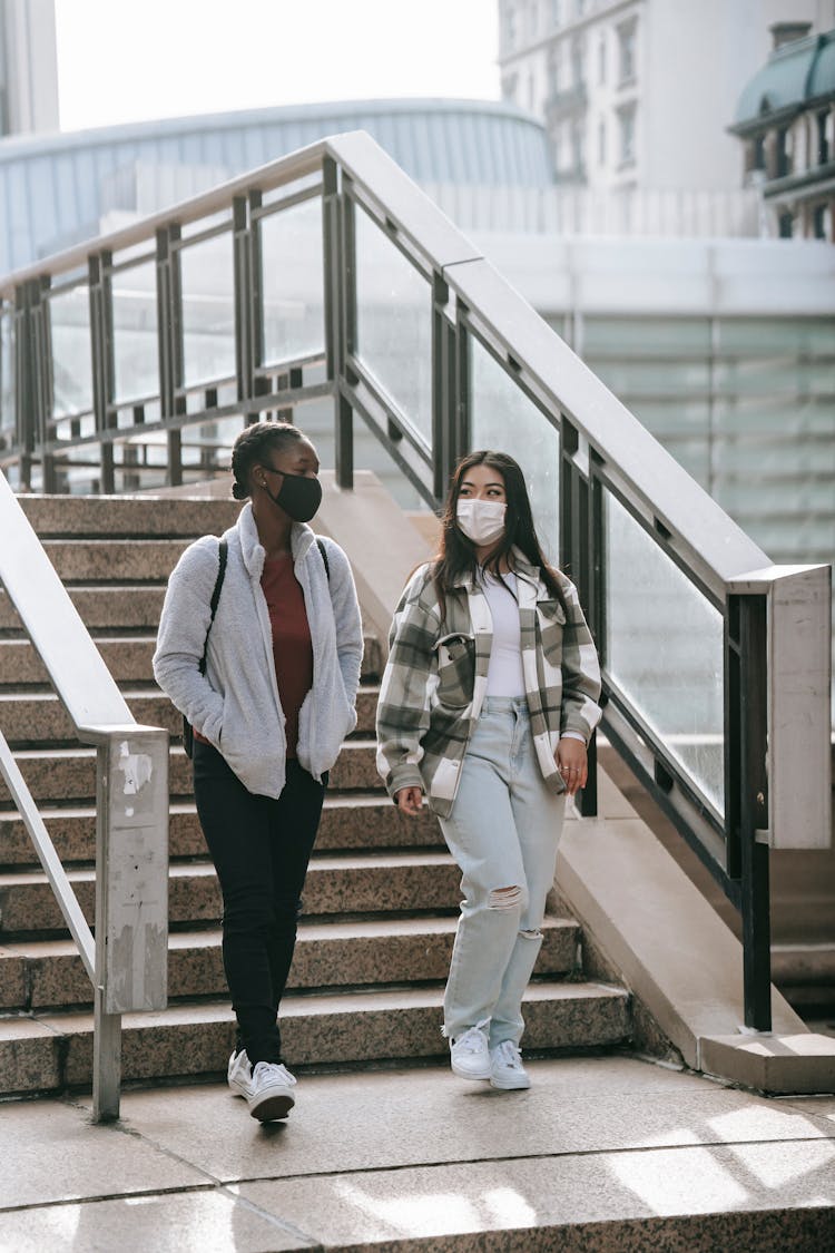 Young Diverse Students In Masks On Stairs