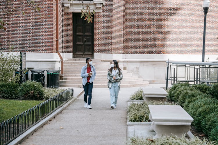 Young Diverse Female Groupmates Walking In Park After Studies