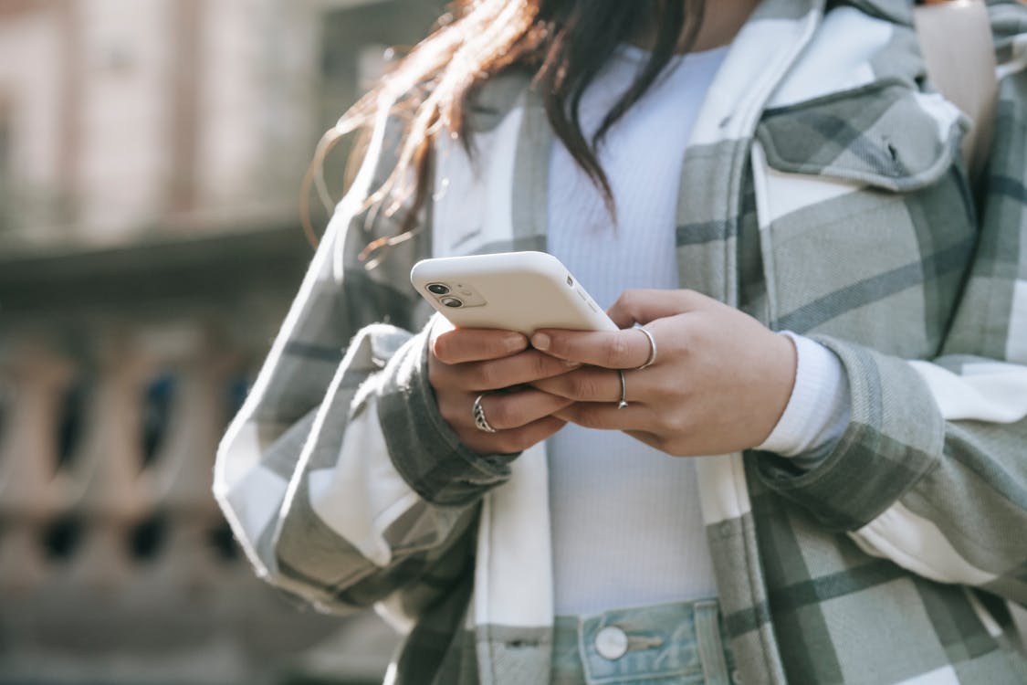 a woman in street with cellphone 