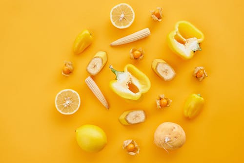 Free Sliced Lemon and Lemon on Yellow Surface Stock Photo