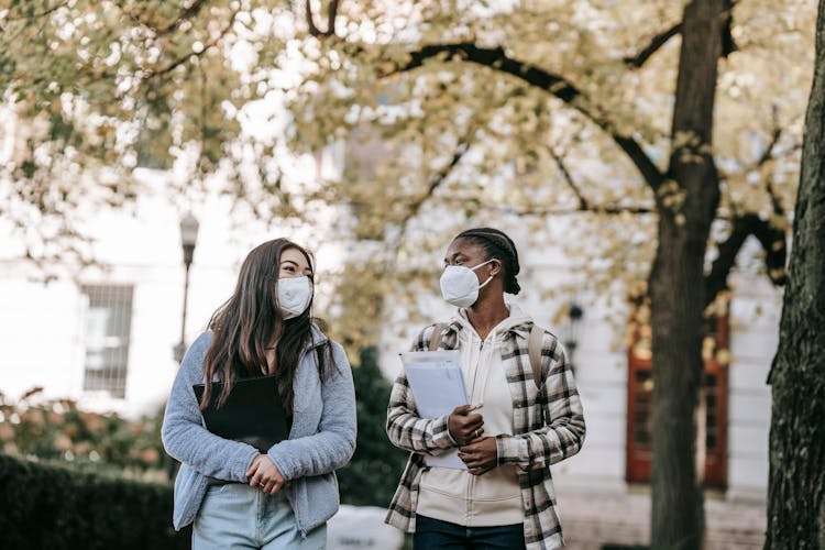 Multiethnic Students With Documents Walking In Park