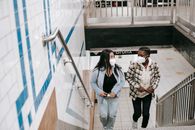 Diverse friends walking upstairs in underground