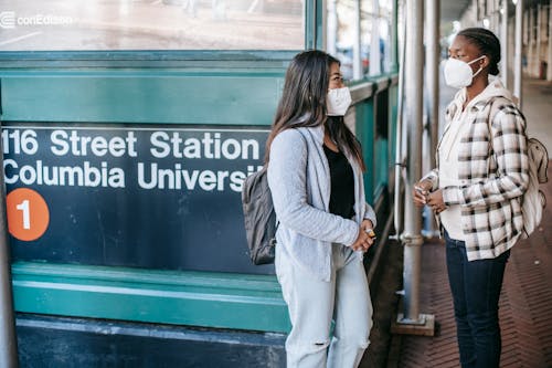 Diverse women standing near metro entrance