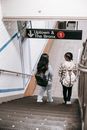 Women with backpacks walking downstairs in underground