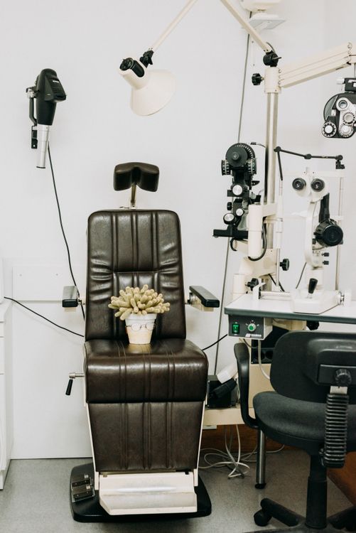 Empty Chair with Eye Test Equipment · Free Stock Photo