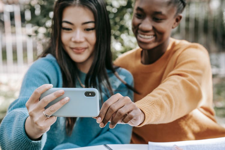 Young Diverse Cheerful Women Taking Selfie With Smartphone