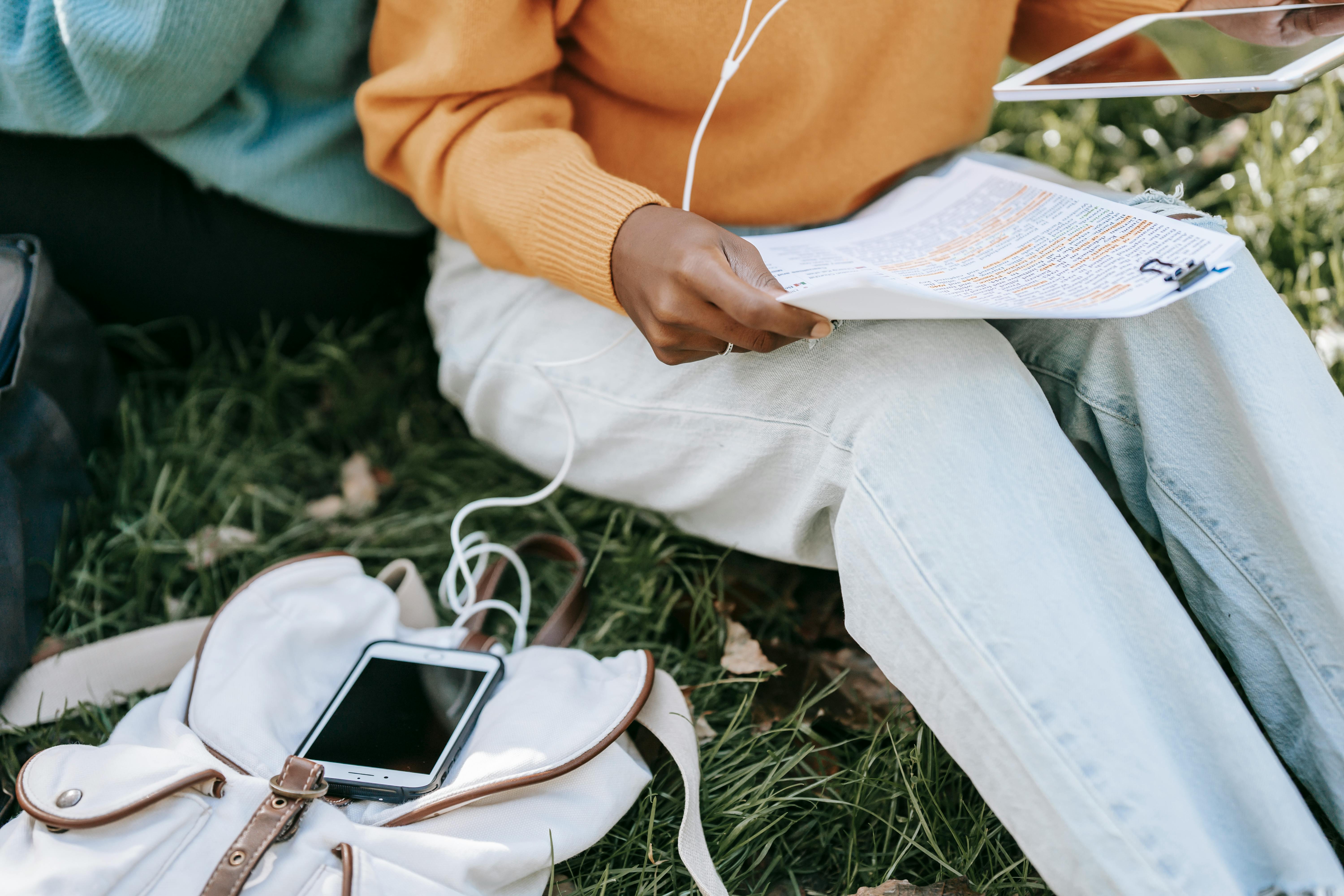 young students preparing for exams in park