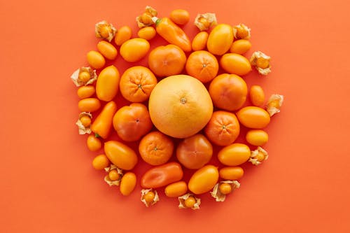 Fruits and Peppers on Orange Surface