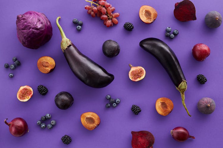 Fruits And Vegetables On Purple Background