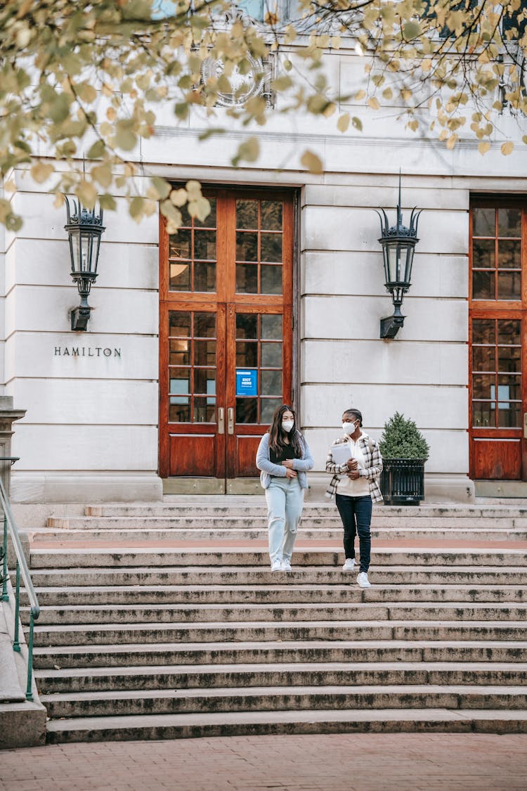 Diverse Students Walking Downstairs From University