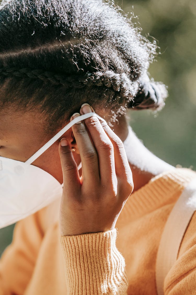 Crop Black Woman Putting On Medical Mask