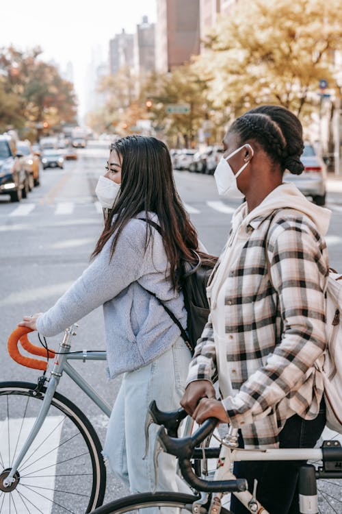 Free Multiracial friends crossing road with bicycles Stock Photo